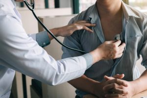 Doctor is using a stethoscope to listen to a heartbeat